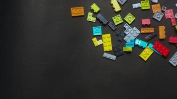 Plastic toy block on a black background photo