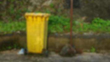 yellow trash can in a tourist place photo