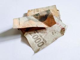 Indonesian shabby banknote with a nominal value of 2000 rupiah isolated white background photo