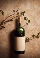 Wine bottle with plant decoration on natural stone background. Product prese photo