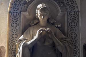 Statue on an old tomb - beginning of 1800, marble - located in Genoa cemetery, Italy photo