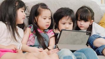 Group of children using tablet in classroom, Multi-ethnic young boys and girls happy using technology for study and play games at elementary school. Kids use technology for education concept. photo