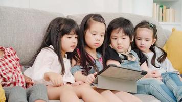 Group of children using tablet in classroom, Multi-ethnic young boys and girls happy using technology for study and play games at elementary school. Kids use technology for education concept. photo