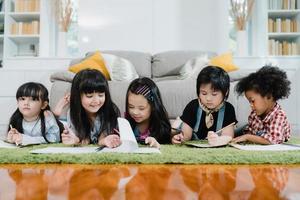 Group of children drawing in classroom, Multi-ethnic young boys and girls happy funny study and play painting on paper at elementary school. Kids drawing and painting at school concept. photo