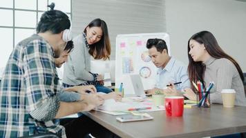 Group of casually dressed business people discussing ideas in the office. Creative professionals gathered at the meeting table for discuss the important issues of the new successful startup project. photo