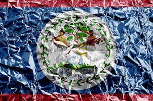 Belize flag depicted in paint colors on shiny crumpled aluminium foil closeup. Textured banner on rough background photo