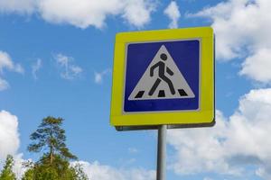 sign of a pedestrian crossing against the blue sky photo