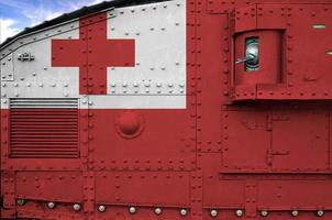 Tonga flag depicted on side part of military armored tank closeup. Army forces conceptual background photo