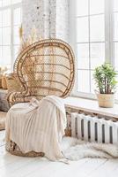 Wicker chair in the room.Boho style interior photo