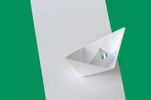 Nigeria flag depicted on paper origami ship closeup. Handmade arts concept photo