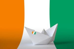 Ivory Coast flag depicted on paper origami ship closeup. Handmade arts concept photo