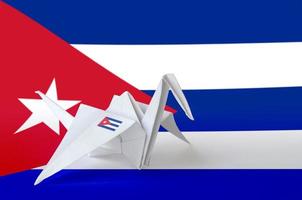 Cuba flag depicted on paper origami crane wing. Handmade arts concept photo