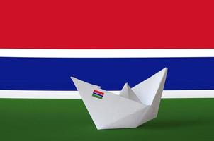 Gambia flag depicted on paper origami ship closeup. Handmade arts concept photo