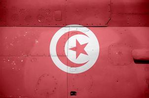 Tunisia flag depicted on side part of military armored helicopter closeup. Army forces aircraft conceptual background photo