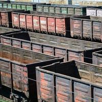 Old empty rusty train cars on rails in summer day photo