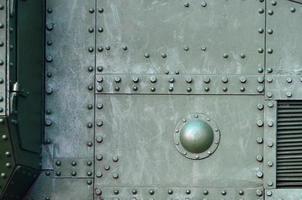 Abstract green industrial metal textured background with rivets and bolts photo