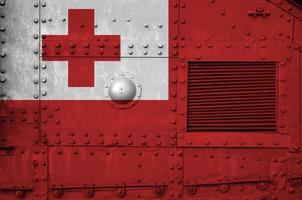 Tonga flag depicted on side part of military armored tank closeup. Army forces conceptual background photo