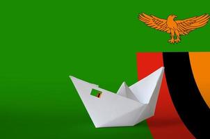 Zambia flag depicted on paper origami ship closeup. Handmade arts concept photo