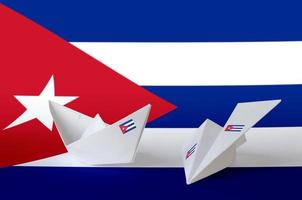 Cuba flag depicted on paper origami airplane and boat. Handmade arts concept photo