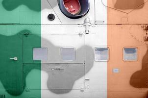 Ireland flag depicted on side part of military armored helicopter closeup. Army forces aircraft conceptual background photo