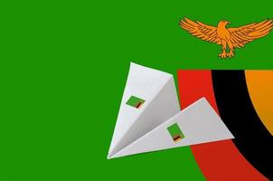 Zambia flag depicted on paper origami airplane. Handmade arts concept photo