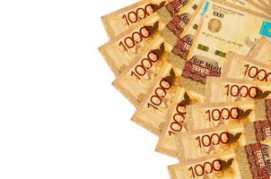 1000 Kazakhstani tenge bills lies isolated on white background with copy space. Rich life conceptual background photo