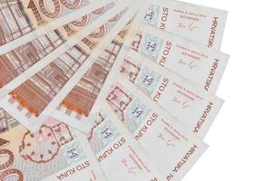 100 Croatian kuna bills lies isolated on white background with copy space stacked in fan shape close up photo