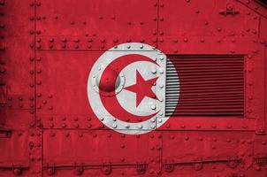 Tunisia flag depicted on side part of military armored tank closeup. Army forces conceptual background photo