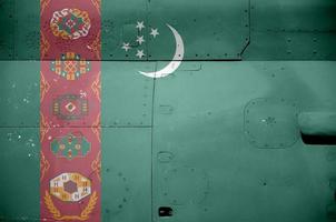 Turkmenistan flag depicted on side part of military armored helicopter closeup. Army forces aircraft conceptual background photo