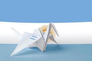 Argentina flag depicted on paper origami crane wing. Handmade arts concept photo