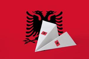 Albania flag depicted on paper origami airplane. Handmade arts concept photo