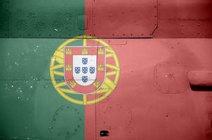 Portugal flag depicted on side part of military armored helicopter closeup. Army forces aircraft conceptual background photo