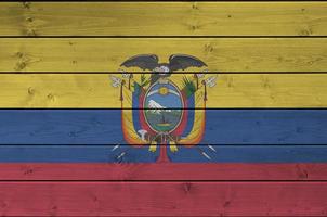 bandera de ecuador representada en colores de pintura brillante en la pared de madera vieja. banner texturizado sobre fondo áspero foto