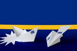 Nauru flag depicted on paper origami airplane and boat. Handmade arts concept photo