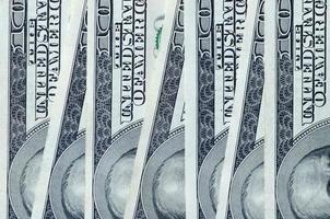 Abstract backdrop with many hundred dollar bills close up photo