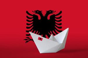 Albania flag depicted on paper origami ship closeup. Handmade arts concept photo