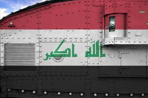 Iraq flag depicted on side part of military armored tank closeup. Army forces conceptual background photo