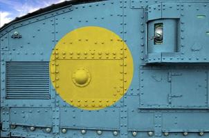 Palau flag depicted on side part of military armored tank closeup. Army forces conceptual background photo