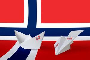 bandera de noruega representada en avión y barco de origami de papel. concepto de artes hechas a mano foto