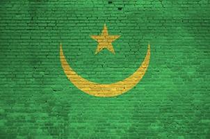 Mauritania flag depicted in paint colors on old brick wall. Textured banner on big brick wall masonry background photo