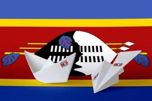 Swaziland flag depicted on paper origami airplane and boat. Handmade arts concept photo