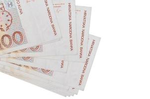 100 Croatian kuna bills lies in small bunch or pack isolated on white. Mockup with copy space. Business and currency exchange photo