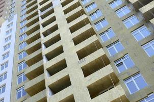 Residential multi store apartement building house facade under construction photo