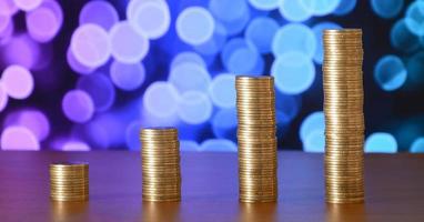 Golden coin stacks arranged as a graph. Increasing columns of coins photo