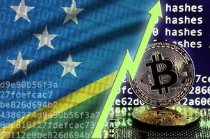 Solomon Islands flag and rising green arrow on bitcoin mining screen and two physical golden bitcoins photo