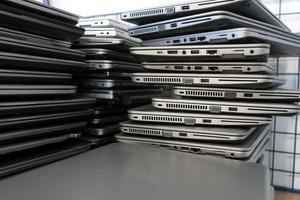 Big stacks of discarded laptops, notebooks on a trolley photo