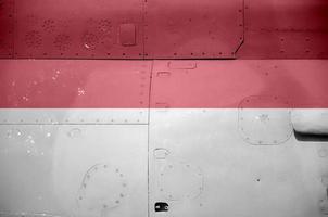 Indonesia flag depicted on side part of military armored helicopter closeup. Army forces aircraft conceptual background photo