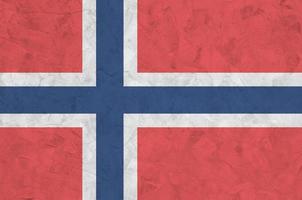 Norway flag depicted in bright paint colors on old relief plastering wall. Textured banner on rough background photo