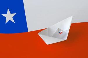 Chile flag depicted on paper origami ship closeup. Handmade arts concept photo