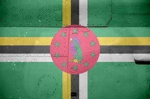 Dominica flag depicted on side part of military armored helicopter closeup. Army forces aircraft conceptual background photo